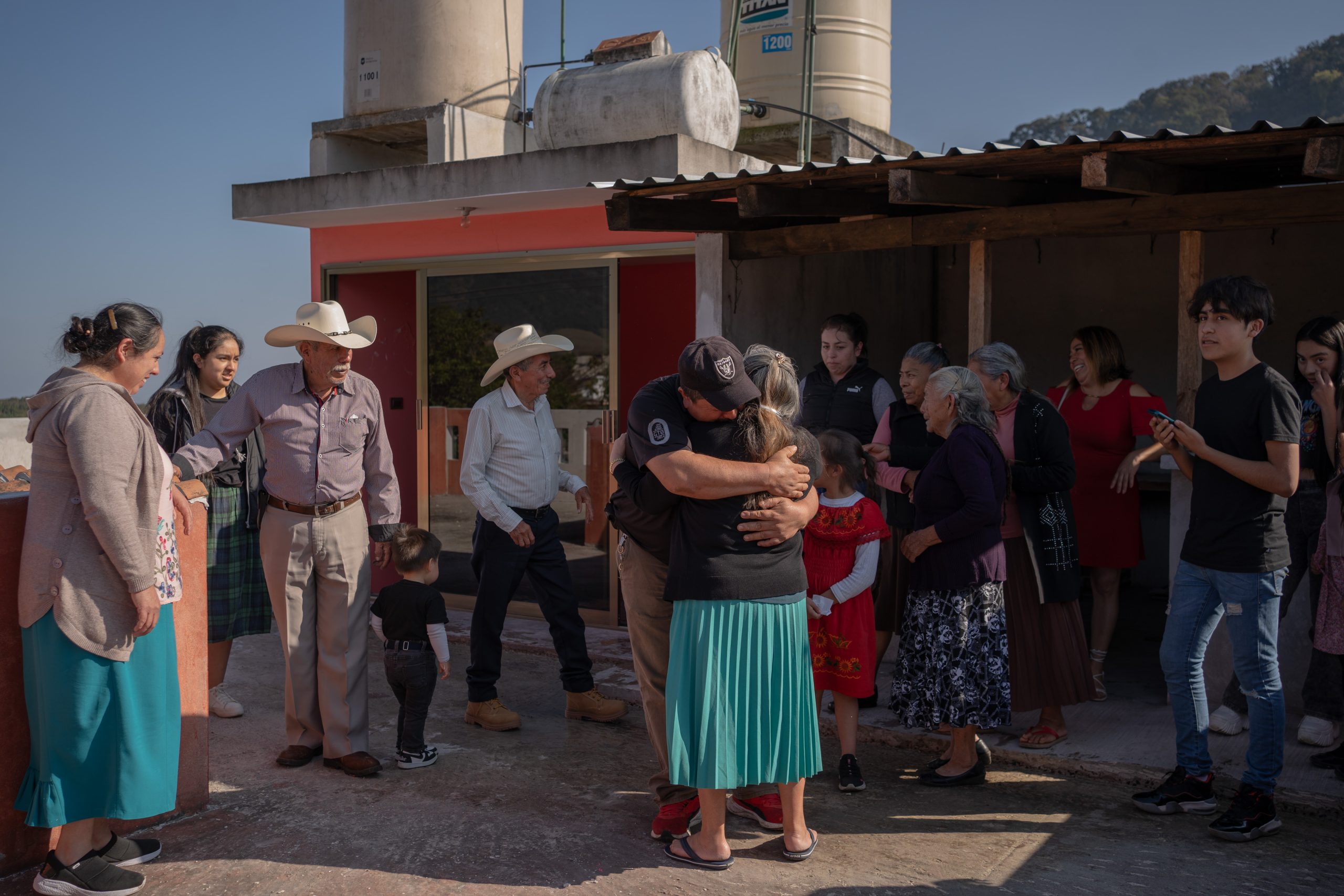 Claudia Perez hugs her nephew Gamaliel Perez, as her family...