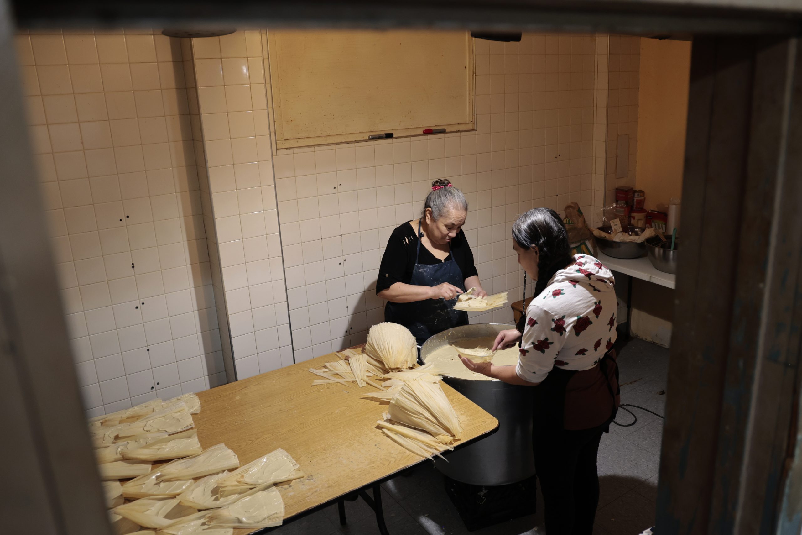 Claudia Perez, left, prepares to make over 1,000 tamales with...