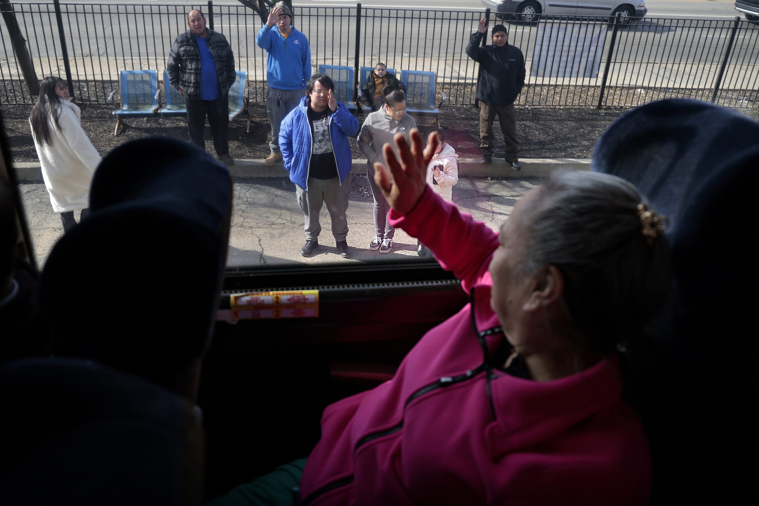 Claudia Perez waves to her family while on a bus,...