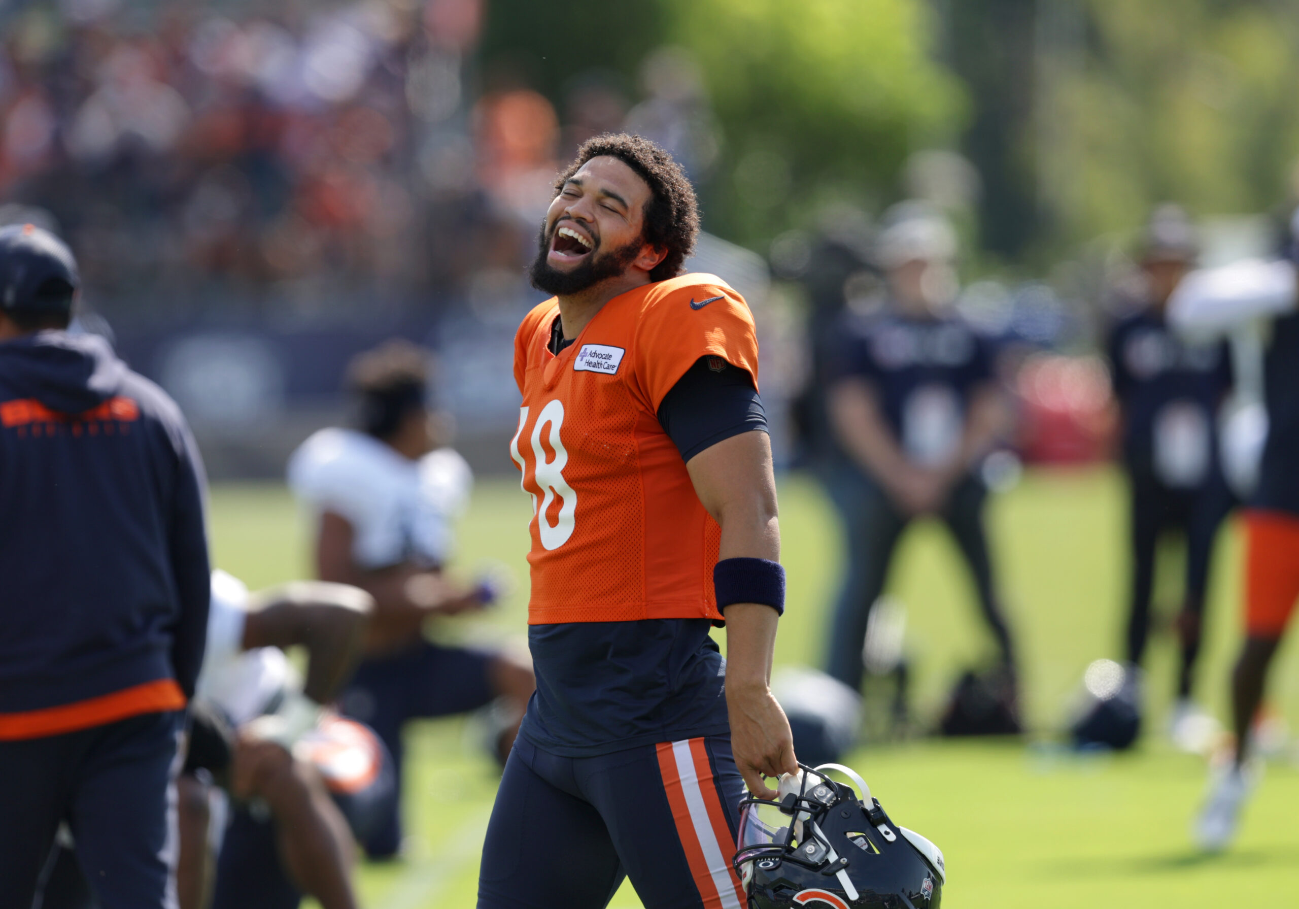 Bears quarterback Caleb Williams jokes with teammates during training camp...