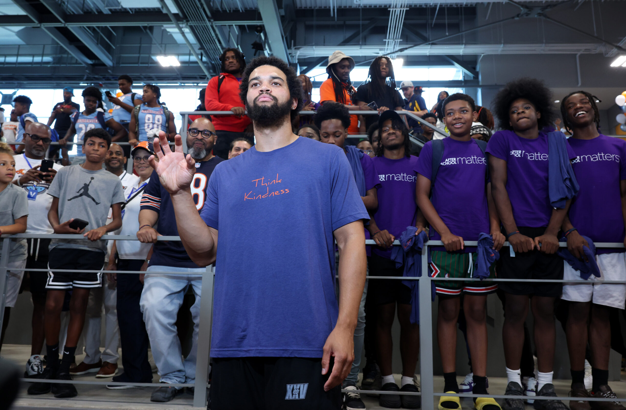 Bears quarterback Caleb Williams poses for pictures during an event...