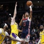 Washington Wizards guard Jordan Poole (13) shoots the ball as Los Angeles Lakers guard Austin Reaves (15) defends