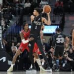 Dec 31, 2024; San Antonio, Texas, USA; San Antonio Spurs center Victor Wembanyama (1) looks to pass against LA Clippers guard Kevin Porter Jr. (77) in the first half at Frost Bank Center.