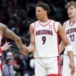 Mar 23, 2025; Seattle, WA, USA; Arizona Wildcats guard Caleb Love (1) high-fives forward Carter Bryant (9) during a stop in play against the Oregon Ducks in the second half at Climate Pledge Arena. Mandatory Credit: Stephen Brashear-Imagn Images