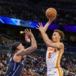 Apr 8, 2025; Orlando, Florida, USA; Atlanta Hawks guard Dyson Daniels (5) shoots the ball over Orlando Magic forward Paolo Banchero (5) during the second quarter at Kia Center. Mandatory Credit: Mike Watters-Imagn Images