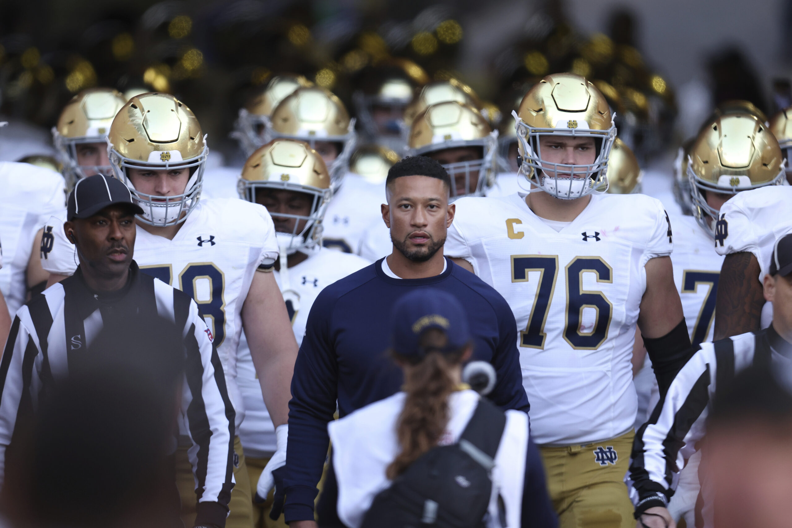Notre Dame coach Marcus Freeman enters the field with his team before a game at Stanford on Nov. 25, 2023. Notre Dame coach Marcus Freeman enters the field with his team before a game at Stanford on Nov. 25, 2023.