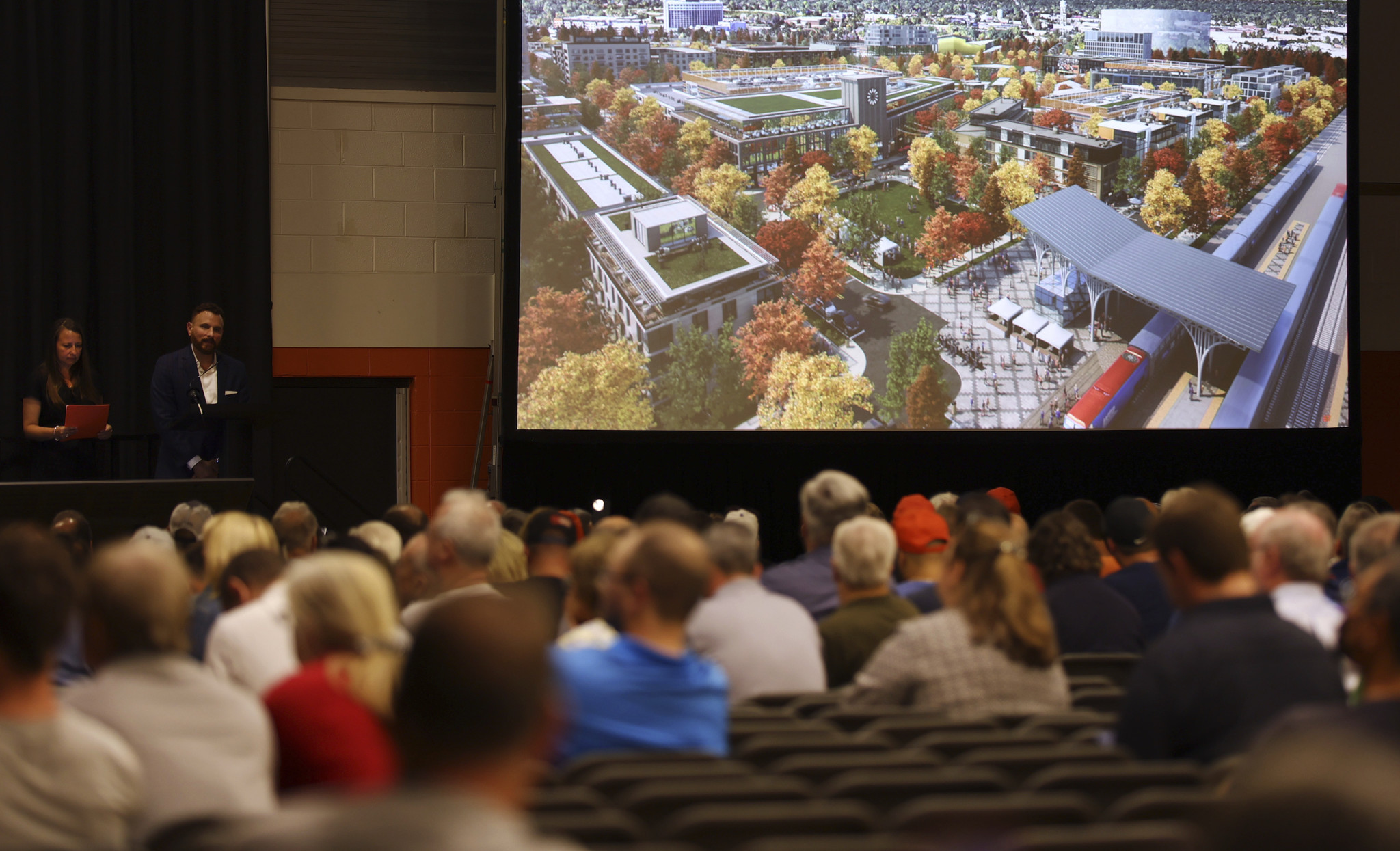 A rendering of the plan is shown as representatives from...