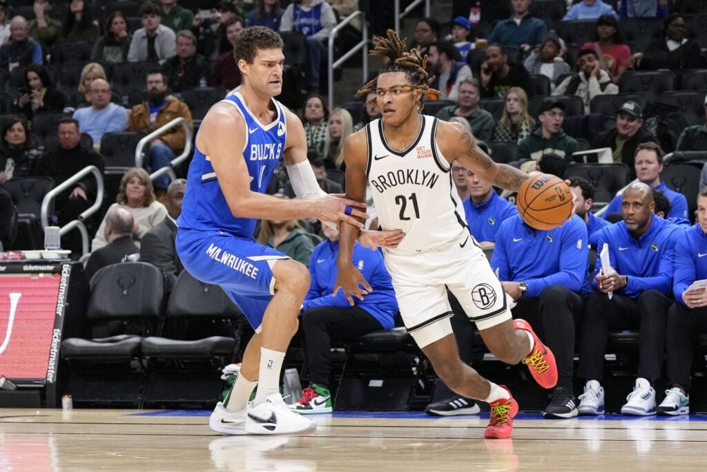 Brooklyn Nets forward Noah Clowney (21) drives for the basket around Milwaukee Bucks center Brook Lopez (11) during the third quarter at Fiserv Forum.