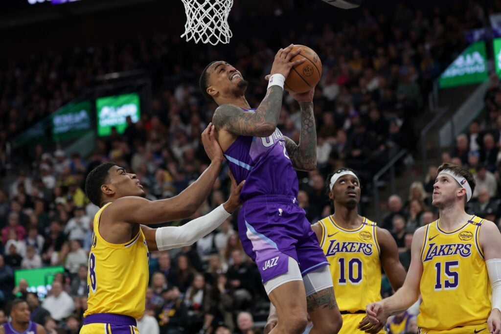 Feb 12, 2025; Salt Lake City, Utah, USA; Utah Jazz forward John Collins (20) shoots against Los Angeles Lakers forward Rui Hachimura (28) during the second half at Delta Center. Mandatory Credit: Chris Nicoll-Imagn Images