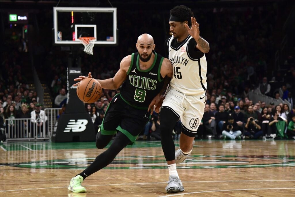 Boston Celtics guard Derrick White (9) controls the ball while Brooklyn Nets guard Keon Johnson (45) defends during the second half at TD Garden.