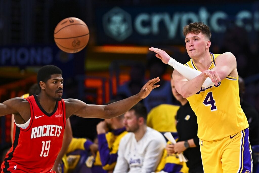 Apr 11, 2025; Los Angeles, California, USA; Los Angeles Lakers guard Dalton Knecht (4) passes against Houston Rockets guard Nate Williams (19) during the second half at Crypto.com Arena. Mandatory Credit: Jonathan Hui-Imagn Images