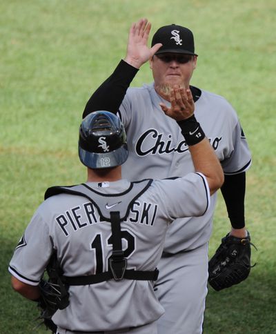 Bobby Jenks #45 of the Chicago White Sox is congratulated by A.J. Pierzynski #12 after collecting a save against the Boston Red Sox on September 4, 2010 at Fenway Park in Boston.