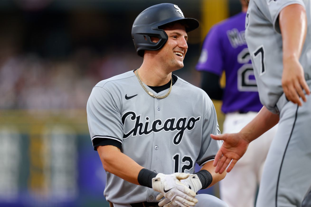 Colson Montgomery #12 of the Chicago White Sox is congratulated by third base coach Justin Jirschele after hitting an RBI triple in the first inning against the Colorado Rockies at Coors Field on July 5, 2025 in Denver, Colorado. The hit was Montgomery’s first of his career.