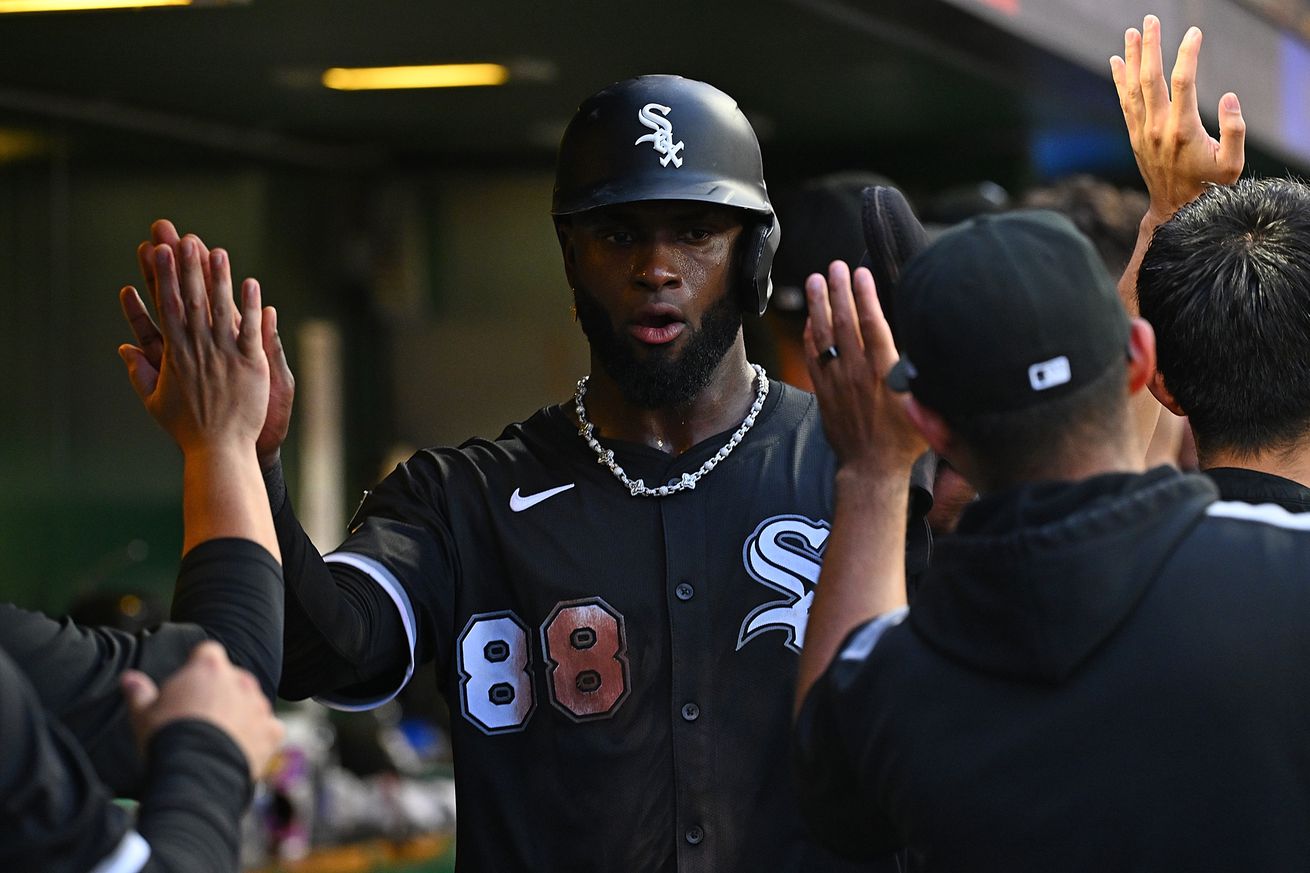 Luis Robert Jr. #88 of the Chicago White Sox celebrates with teammates in the dugout after coming around to score on a three run RBI double by Mike Tauchman #18 (not pictured) in the sixth inning during the game against the Pittsburgh Pirates at PNC Park on July 19, 2025 in Pittsburgh, Pennsylvania.