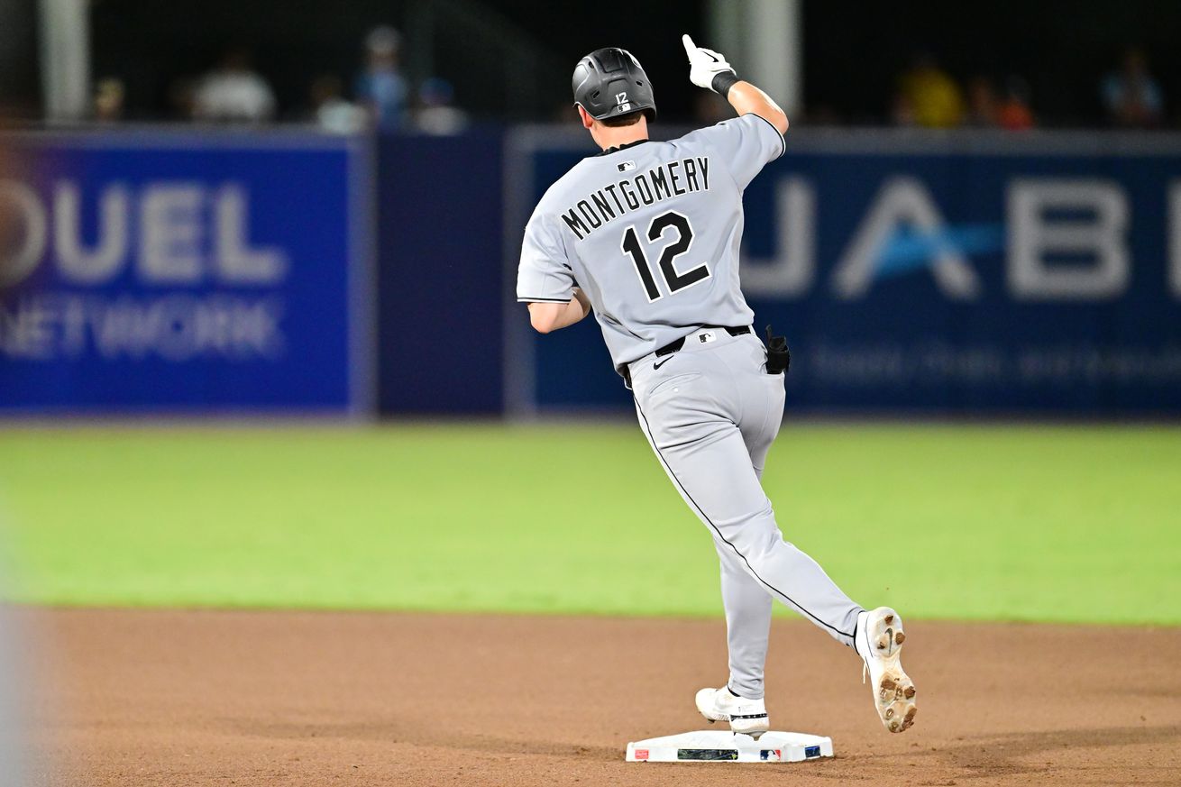 Colson Montgomery rounds second base, pointing out towards left field in celebration of his first home run in the seventh inning of the White Sox vs Rays game on July 22.
