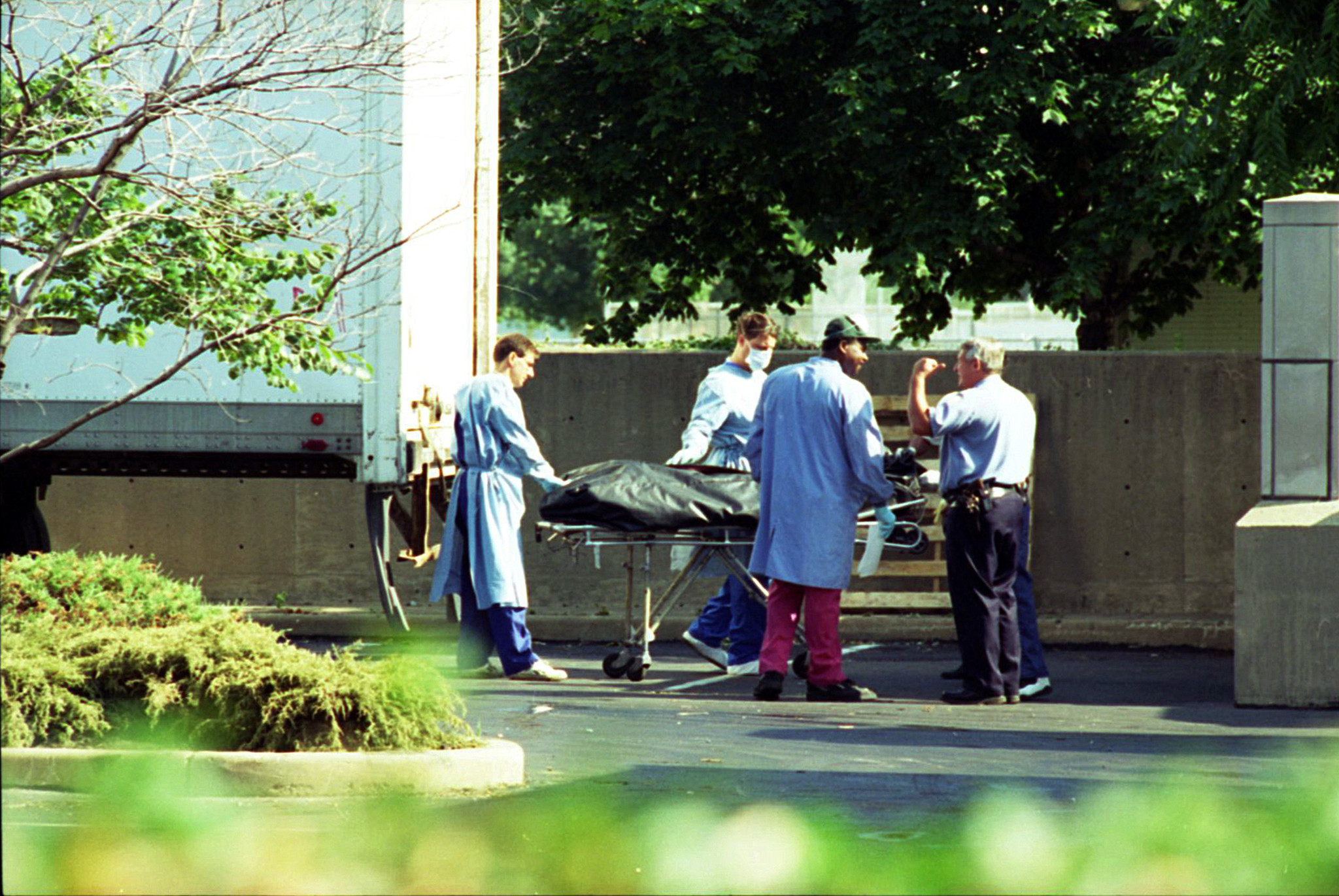 Workers at the Cook County medical examiner's office move a...