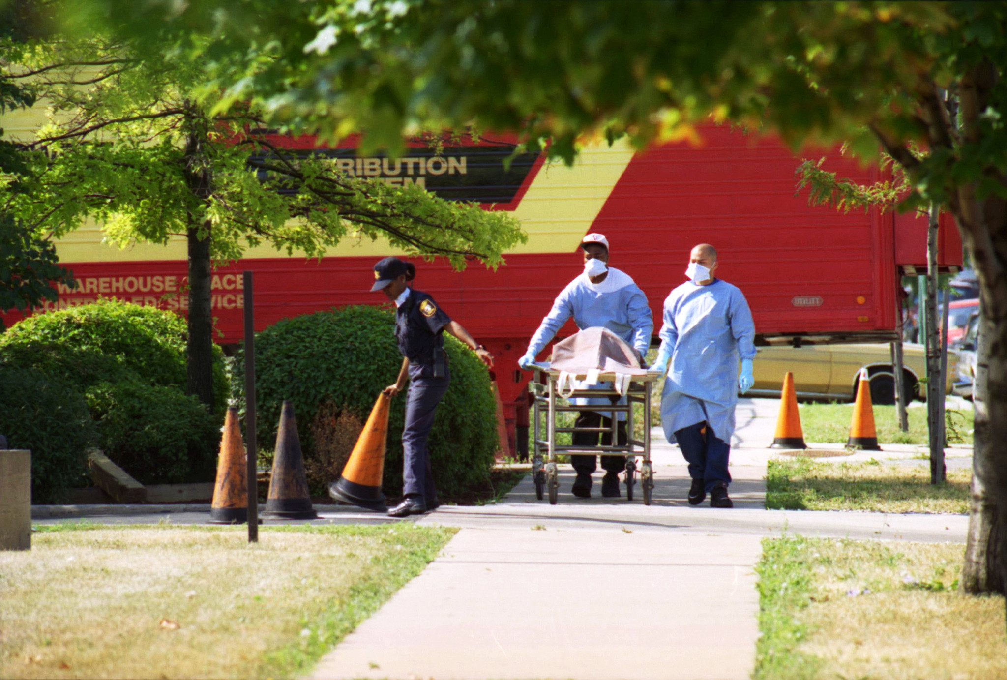 Employees at the Cook County morgue move a body from...