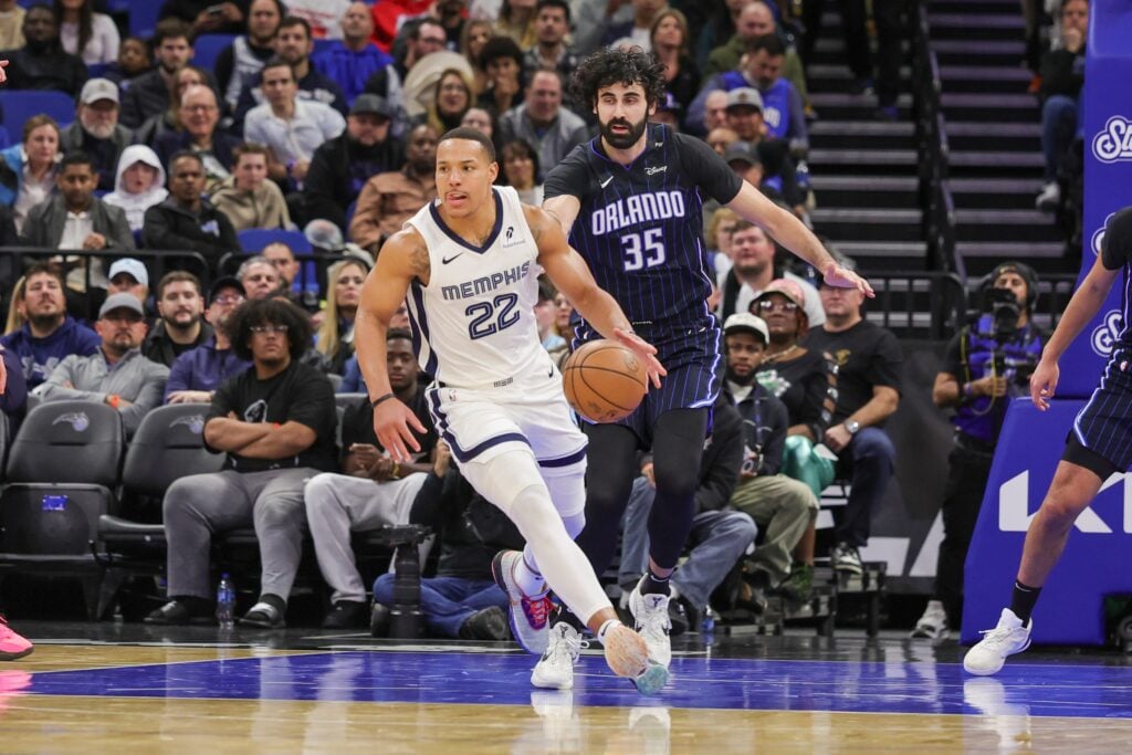 Feb 21, 2025; Orlando, Florida, USA; Memphis Grizzlies guard Desmond Bane (22) moves the ball in front of Orlando Magic center Goga Bitadze (35) during the second quarter at Kia Center. Mandatory Credit: Mike Watters-Imagn Images
