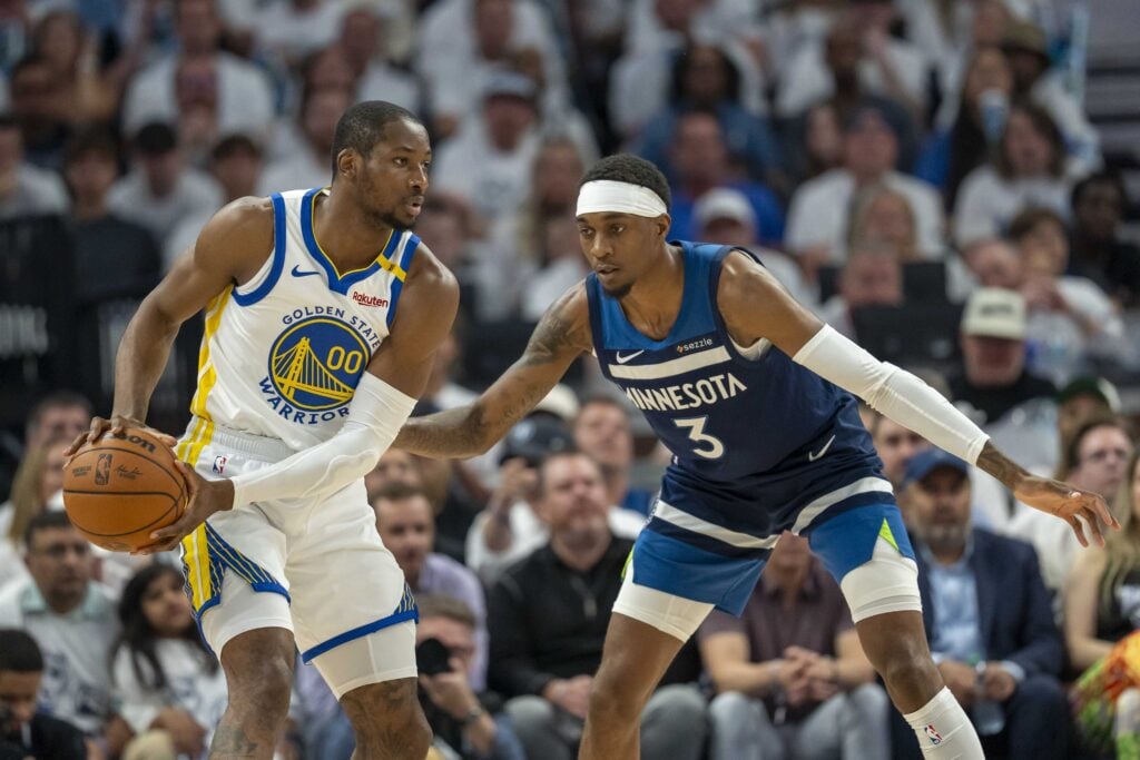May 14, 2025; Minneapolis, Minnesota, USA; Golden State Warriors forward Jonathan Kuminga (00) looks to pass the ball as Minnesota Timberwolves forward Jaden McDaniels (3) plays defense in the first half during game five of the second round for the 2025 NBA Playoffs at Target Center. Mandatory Credit: Jesse Johnson-Imagn Images
