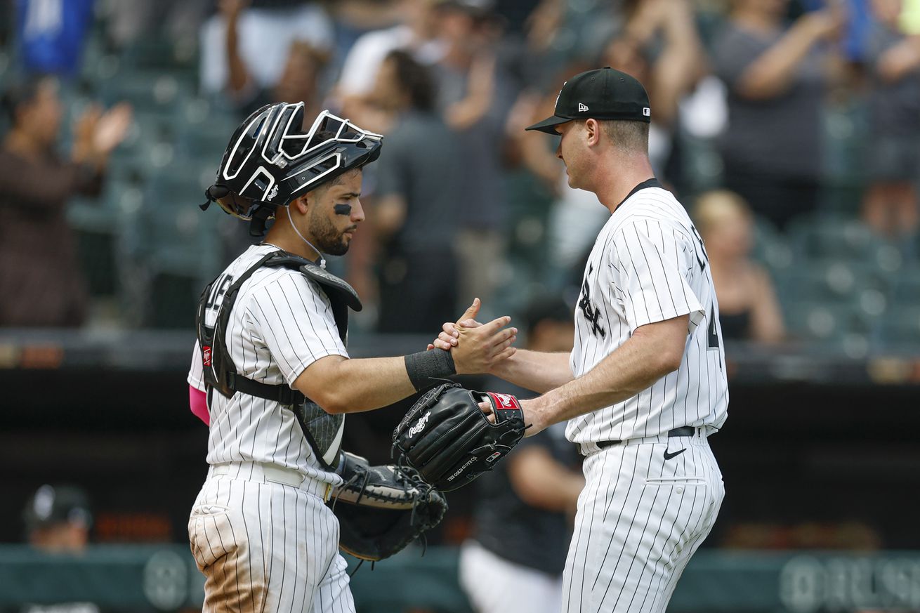 Chicago White Sox pitcher Jordan Leasure (R) celebrates with catcher Edgar Quero (L) team’s win against the Toronto Blue Jays at Rate Field.