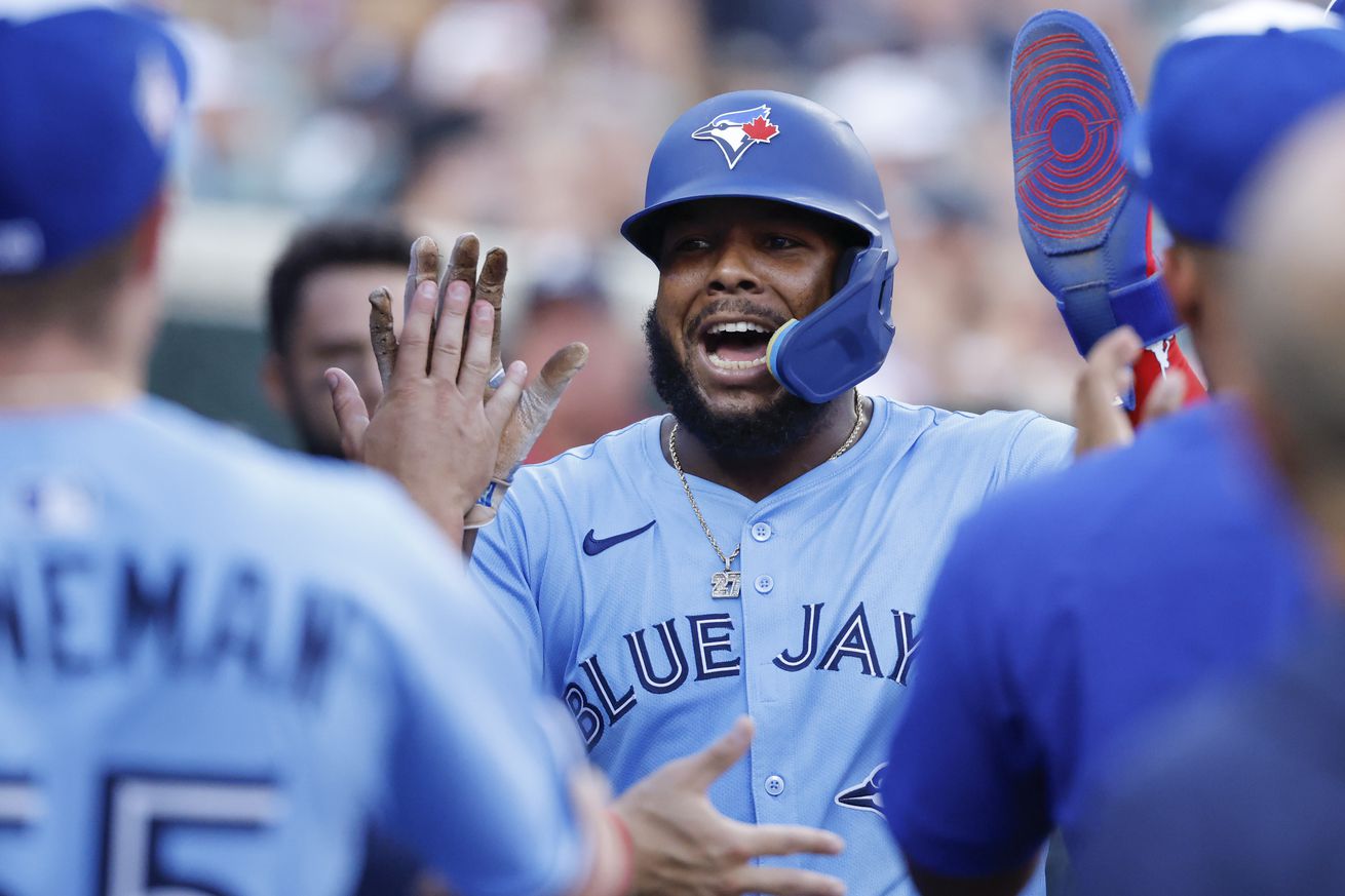 Toronto Blue Jays first baseman Vladimir Guerrero Jr. (27) is congratulated by teammates after scoring in the fourth inning against the Detroit Tigers at Comerica Park.