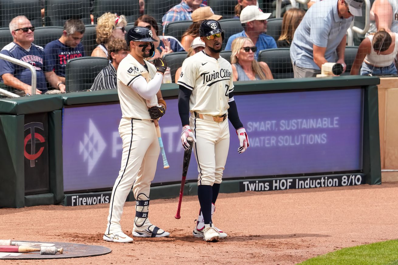 Byron Buxton #25 and Royce Lewis #23 of the Minnesota Twins look on against the Chicago White Sox on August 4, 2024 at Target Field in Minneapolis, Minnesota.