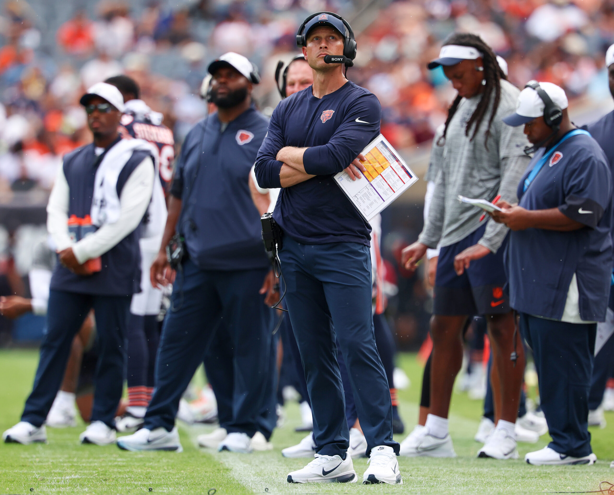 Chicago Bears head coach Ben Johnson watches the Jumbotron in...