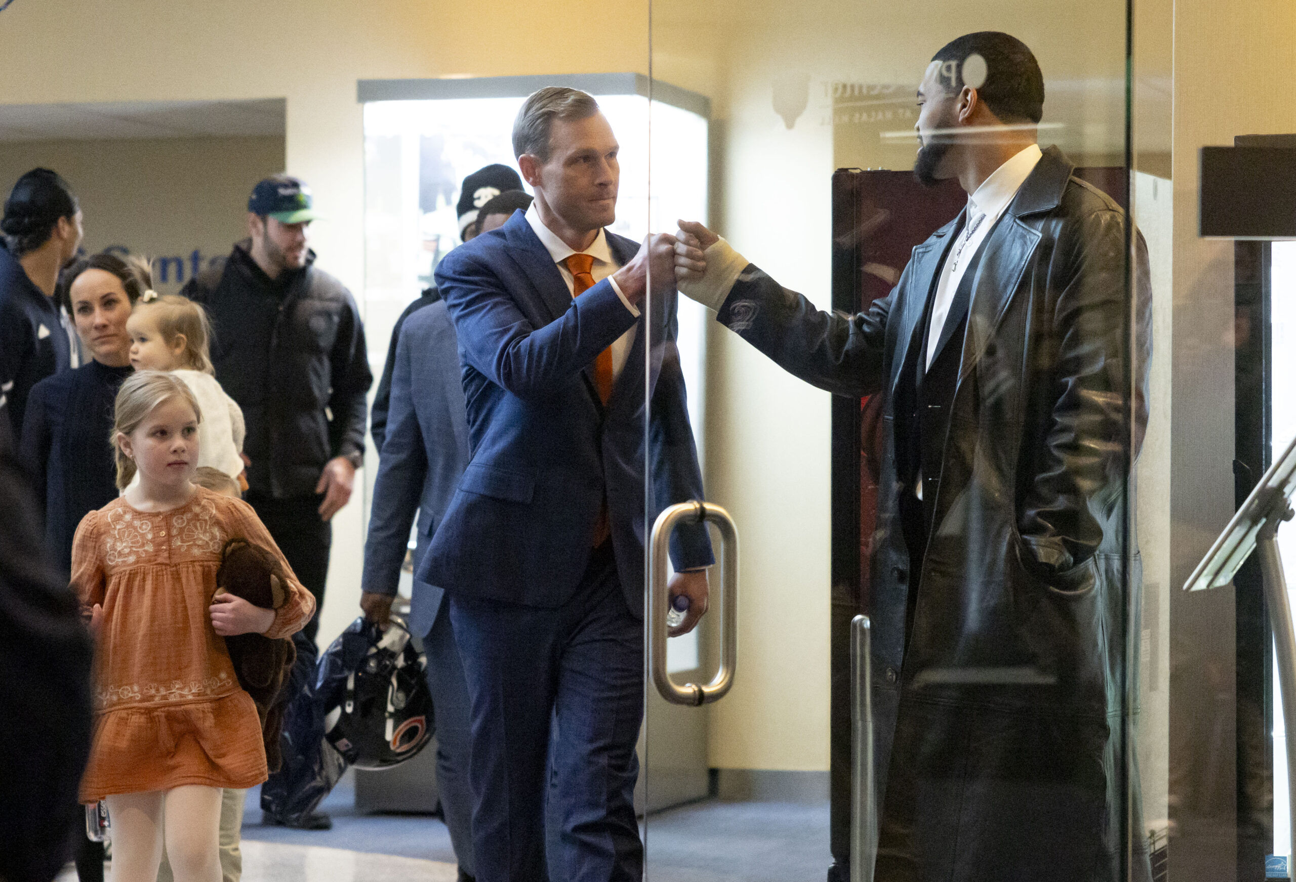 New Bears coach Ben Johnson greets quarterback Caleb Williams before...