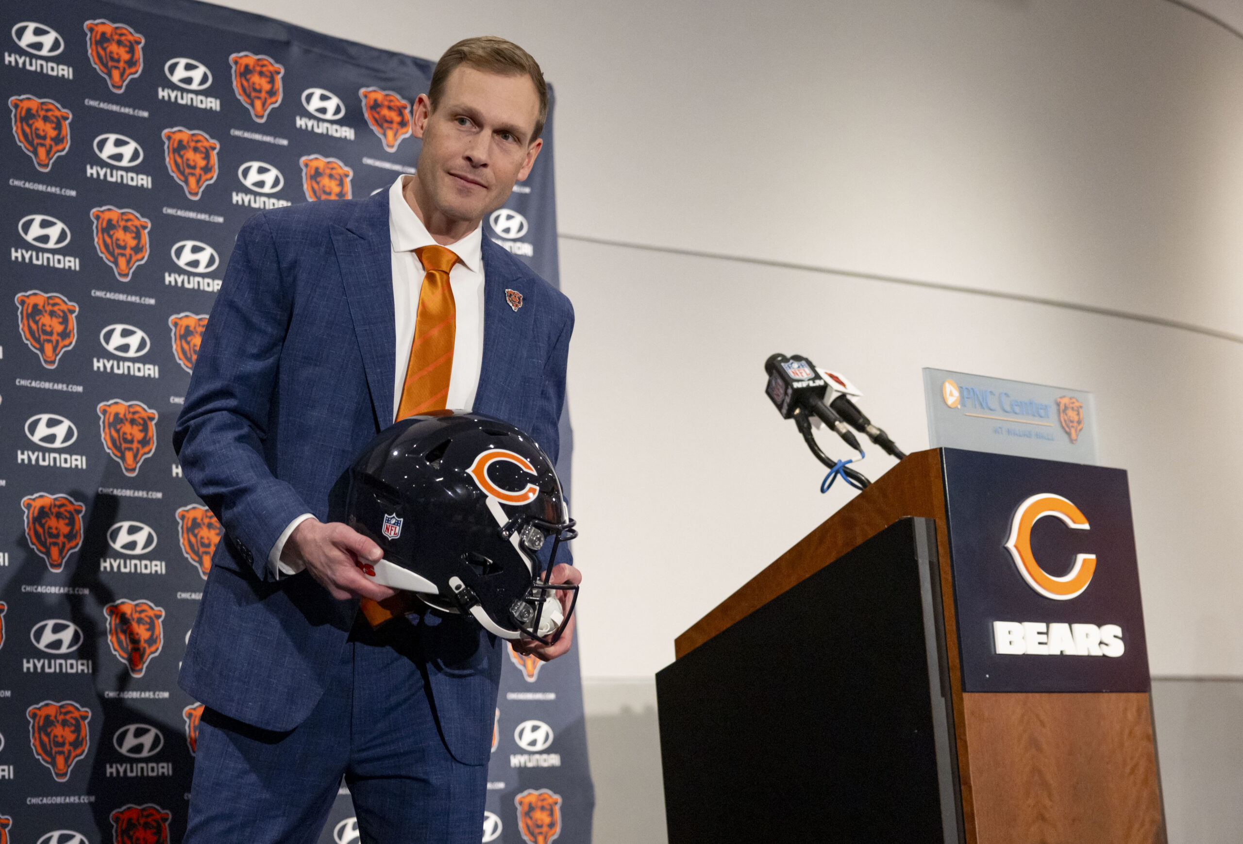 New Chicago Bears coach Ben Johnson holds a helmet after...