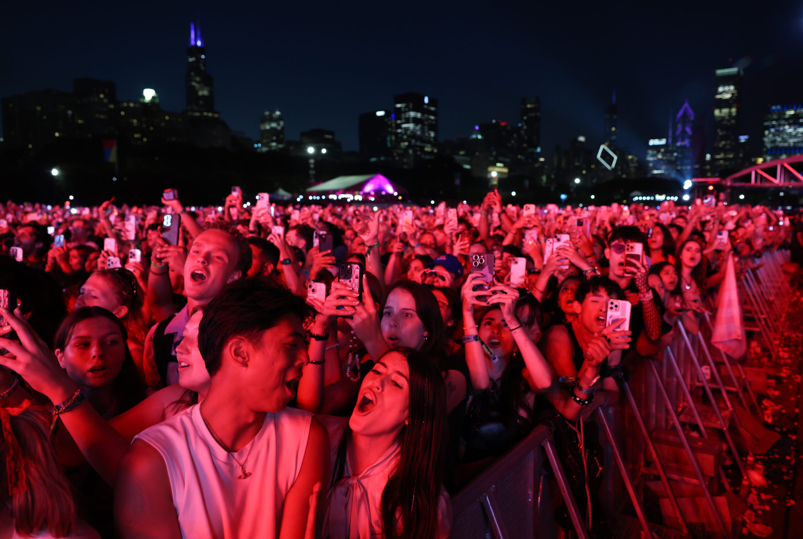 Festival attendees sing the lyrics to a song as Olivia...