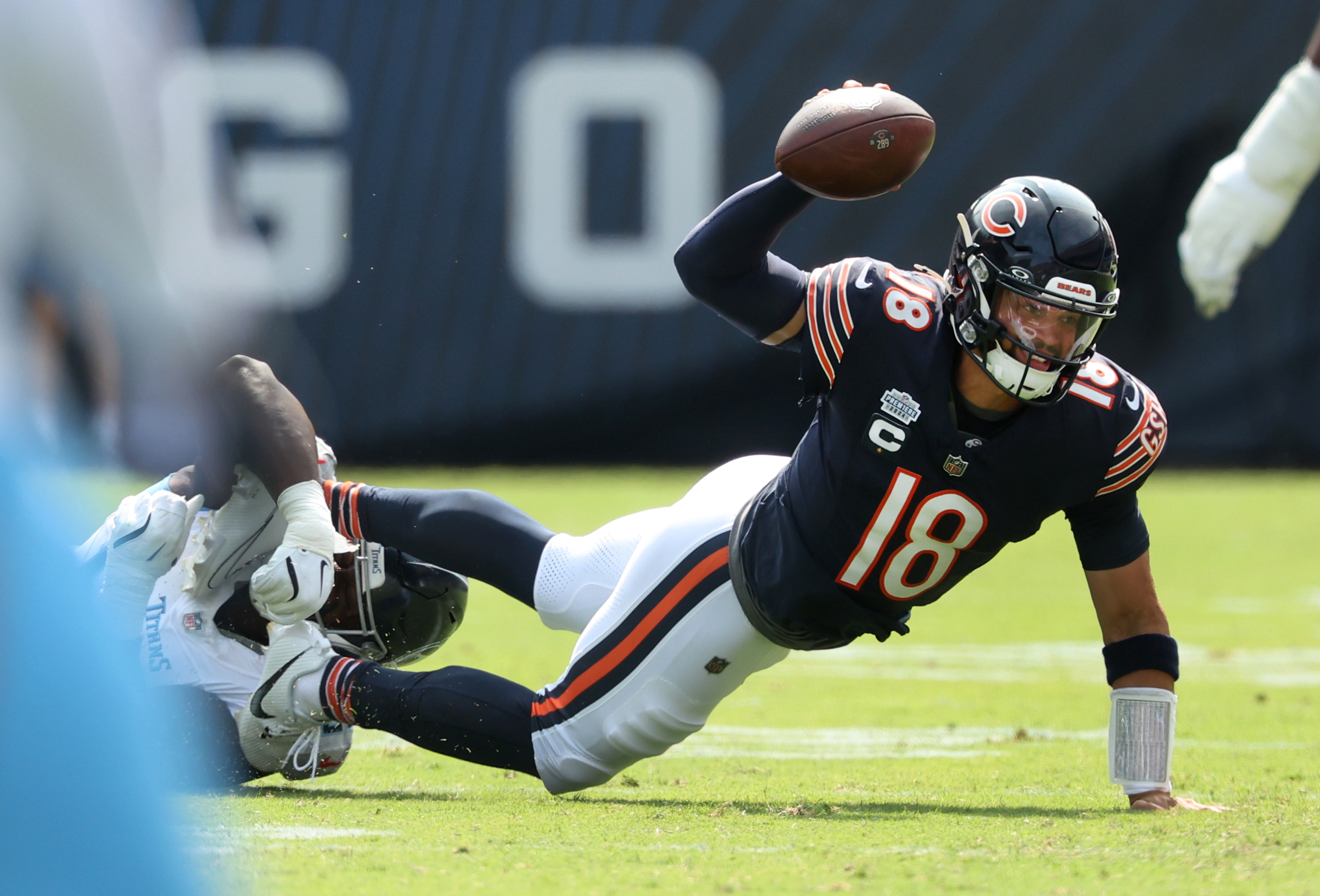 Titans defensive tackle Sebastian Joseph-Day sacks Bears quarterback Caleb Williams...
