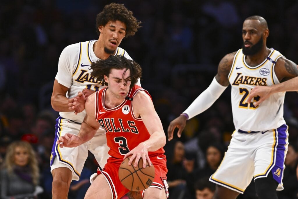 Mar 22, 2025; Los Angeles, California, USA; Chicago Bulls guard Josh Giddey (3) moves the ball against Los Angeles Lakers center Jaxson Hayes (11) and forward LeBron James (23) during the first half at Crypto.com Arena. Mandatory Credit: Jonathan Hui-Imagn Images