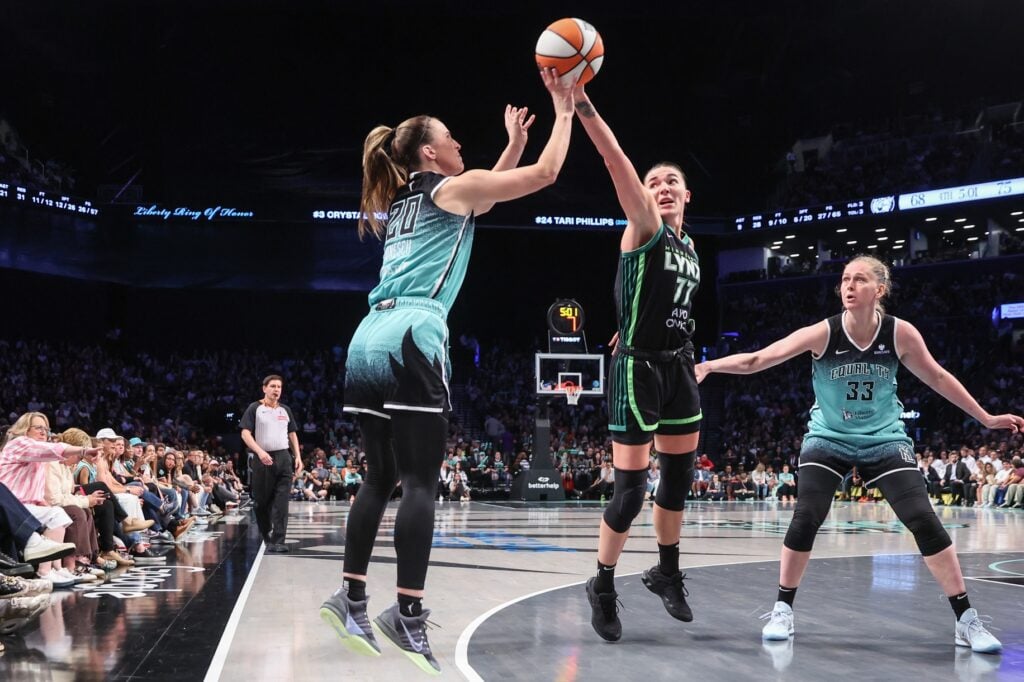 Aug 19, 2025; Brooklyn, New York, USA; Minnesota Lynx forward Maria Kliundikova (77) attempts to block a three point shot attempt by New York Liberty guard Sabrina Ionescu (20) in the fourth quarter at Barclays Center. Mandatory Credit: Wendell Cruz-Imagn Images