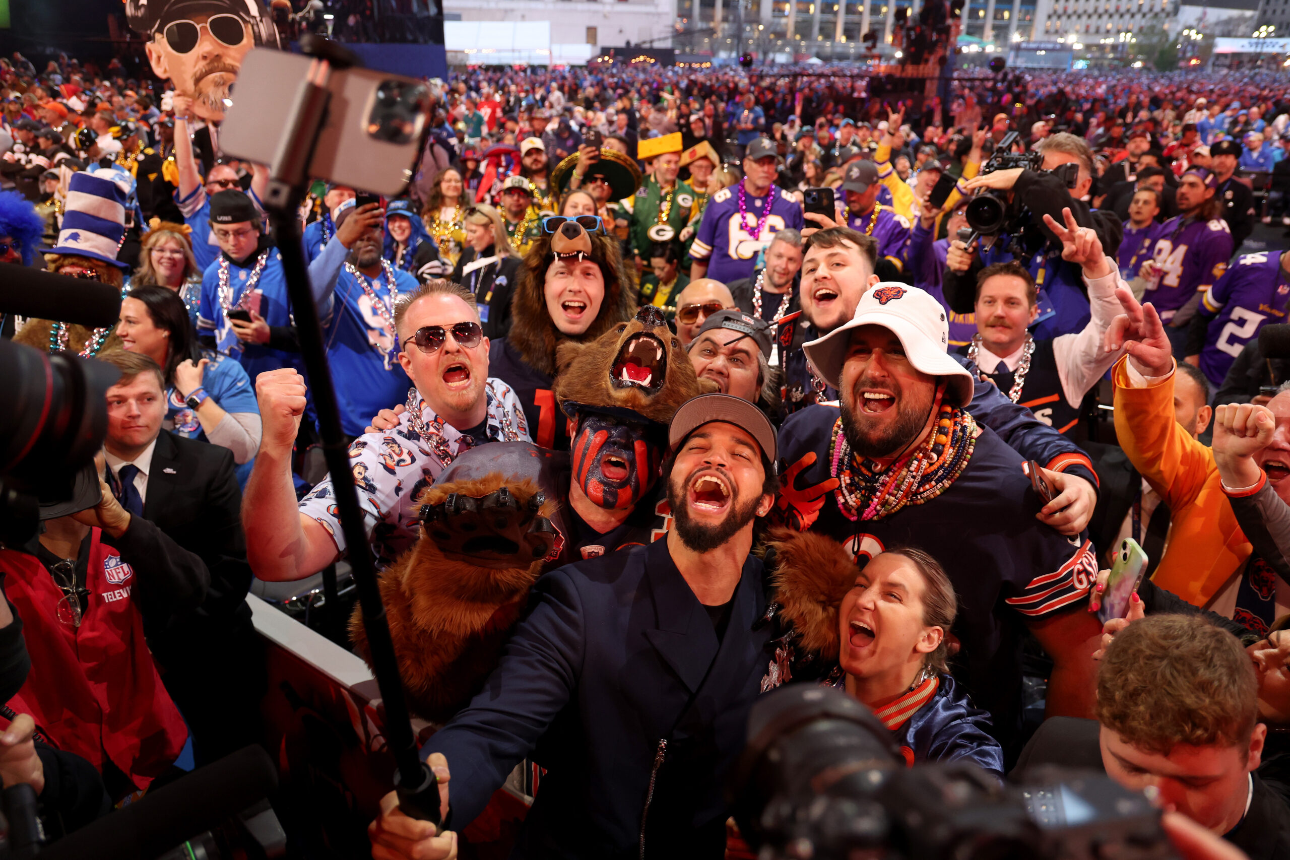 Caleb Williams celebrates with fans after being selected first overall...