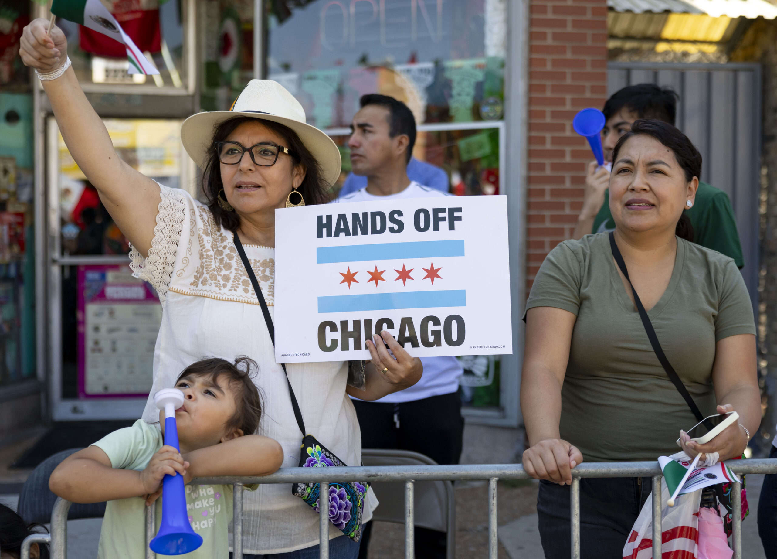 A woman holds a sign while watching the annual 26th...