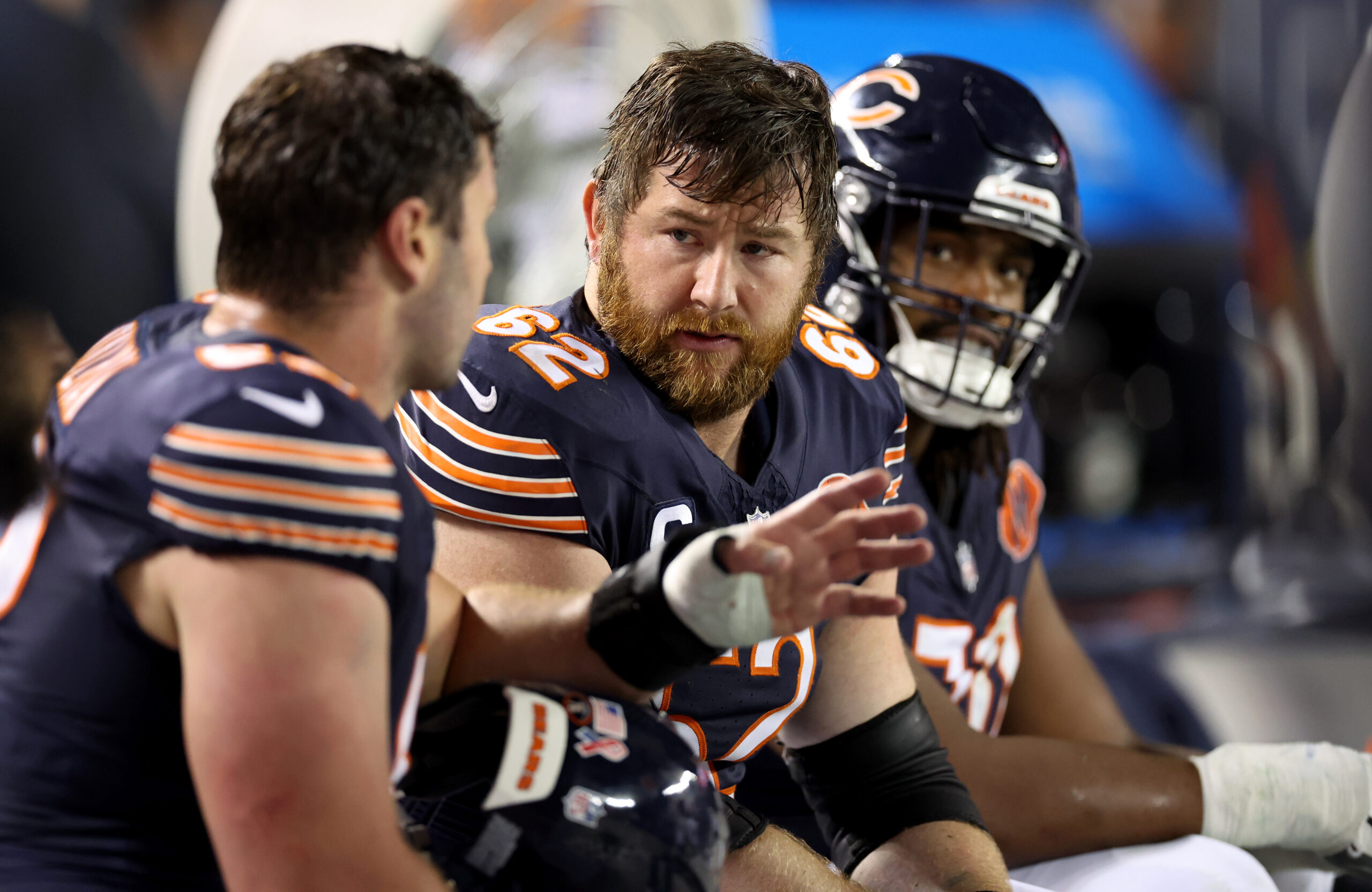 Chicago Bears guard Joe Thuney (center) chats with his teammates...
