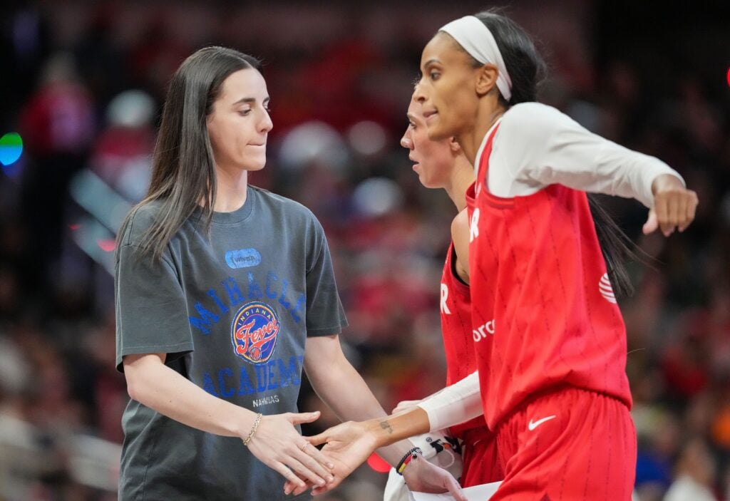 Indiana Fever guard Caitlin Clark (22) high-flves Indiana Fever forward DeWanna Bonner (25) on Friday, May 30, 2025, during the game at Gainbridge Fieldhouse in Indianapolis. The Connecticut Sun defeated the Indiana Fever