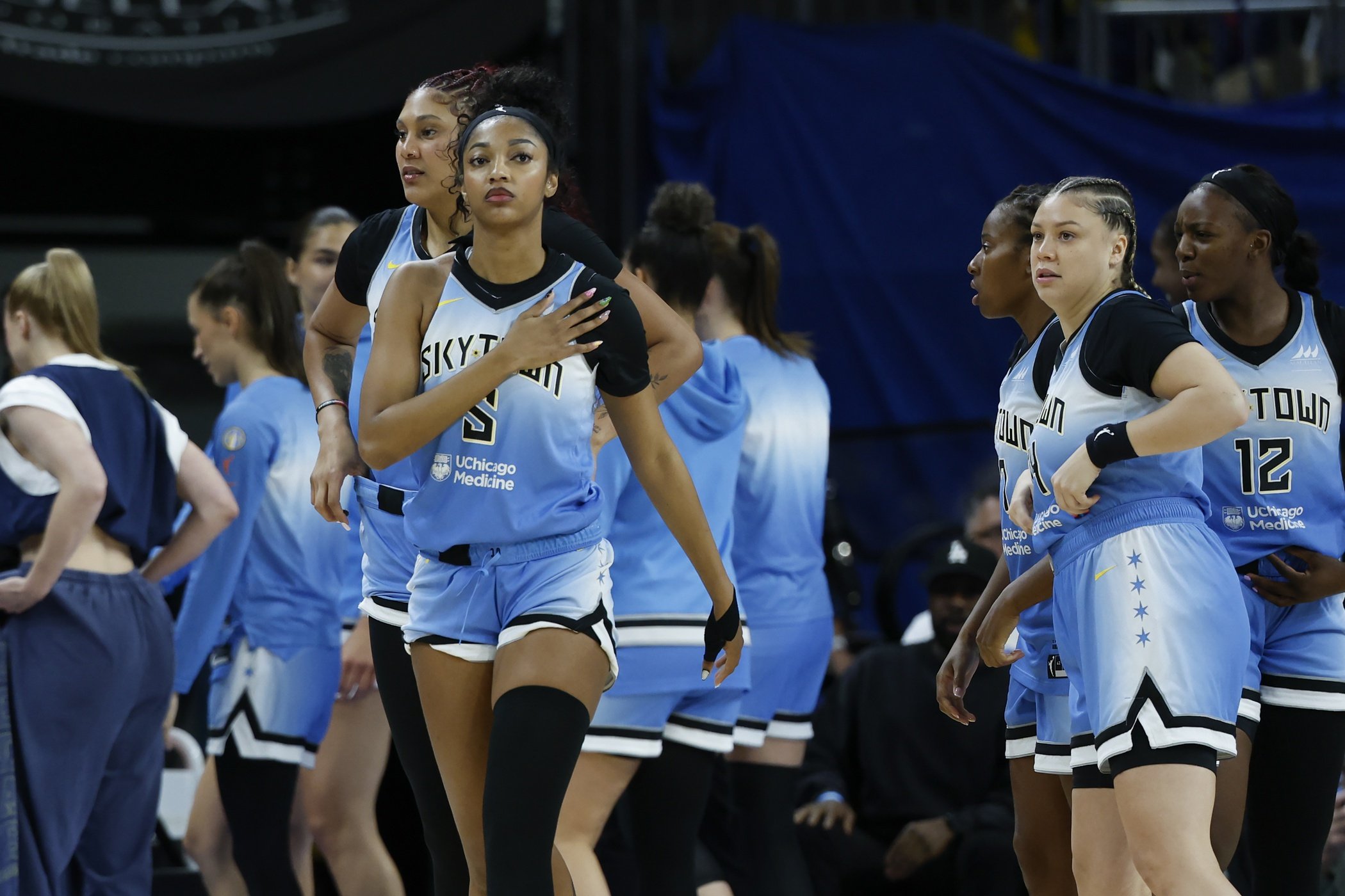 Chicago Sky forward Angel Reese (5) walks on the court next to her teammates before a WNBA game against the Connecticut Sun at Wintrust Arena.