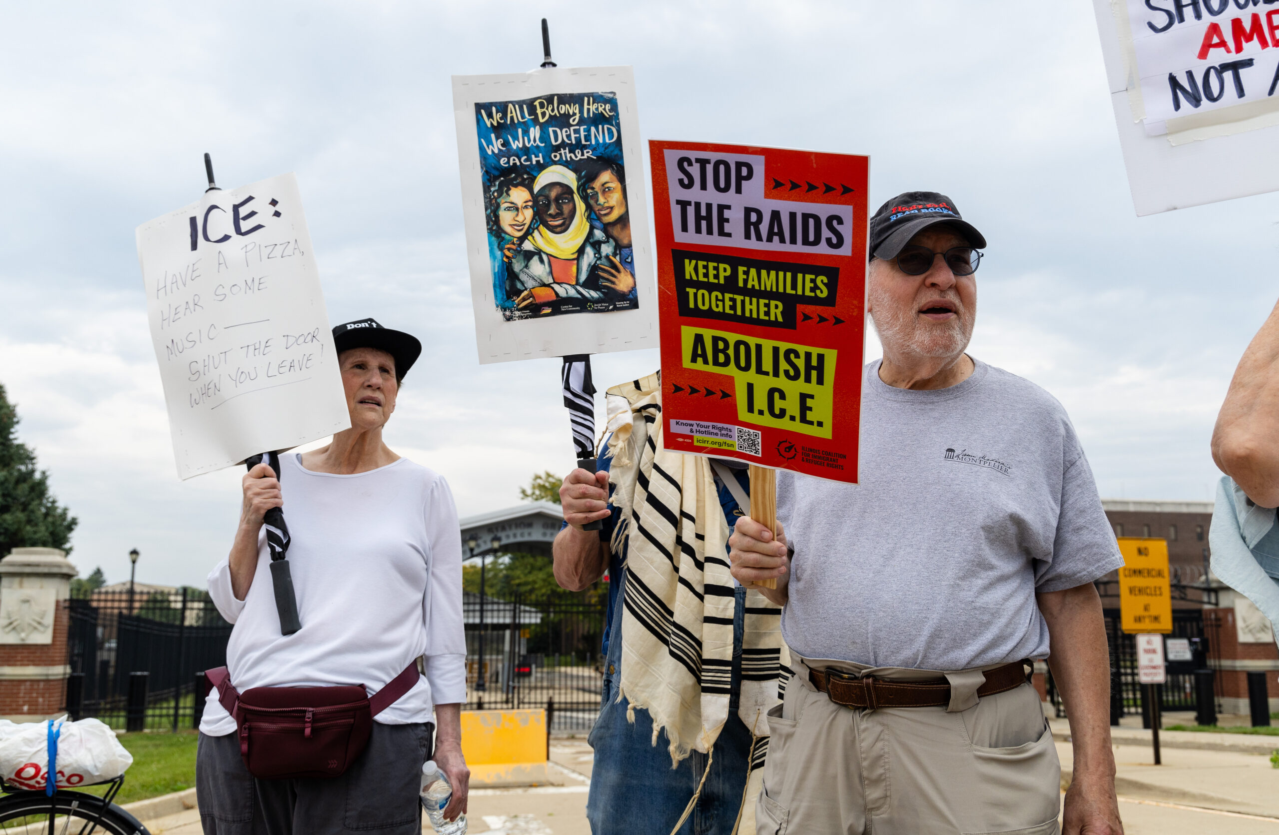 Protesters participate in an interfaith prayer march in a circle...