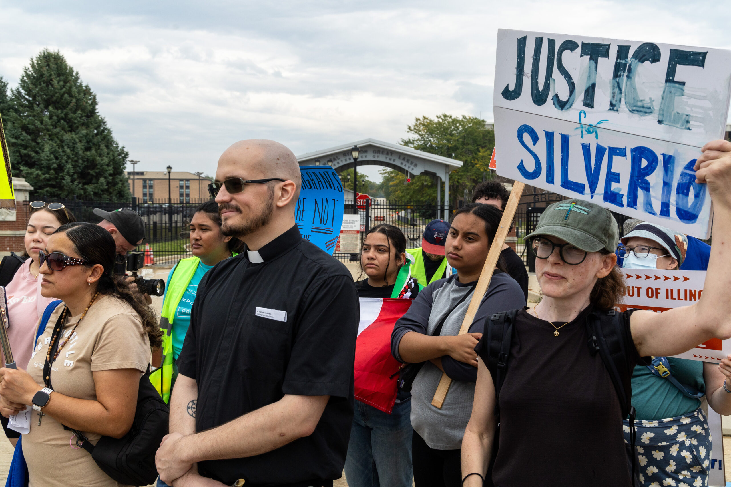 Protesters participate in an interfaith prayer march in a circle...