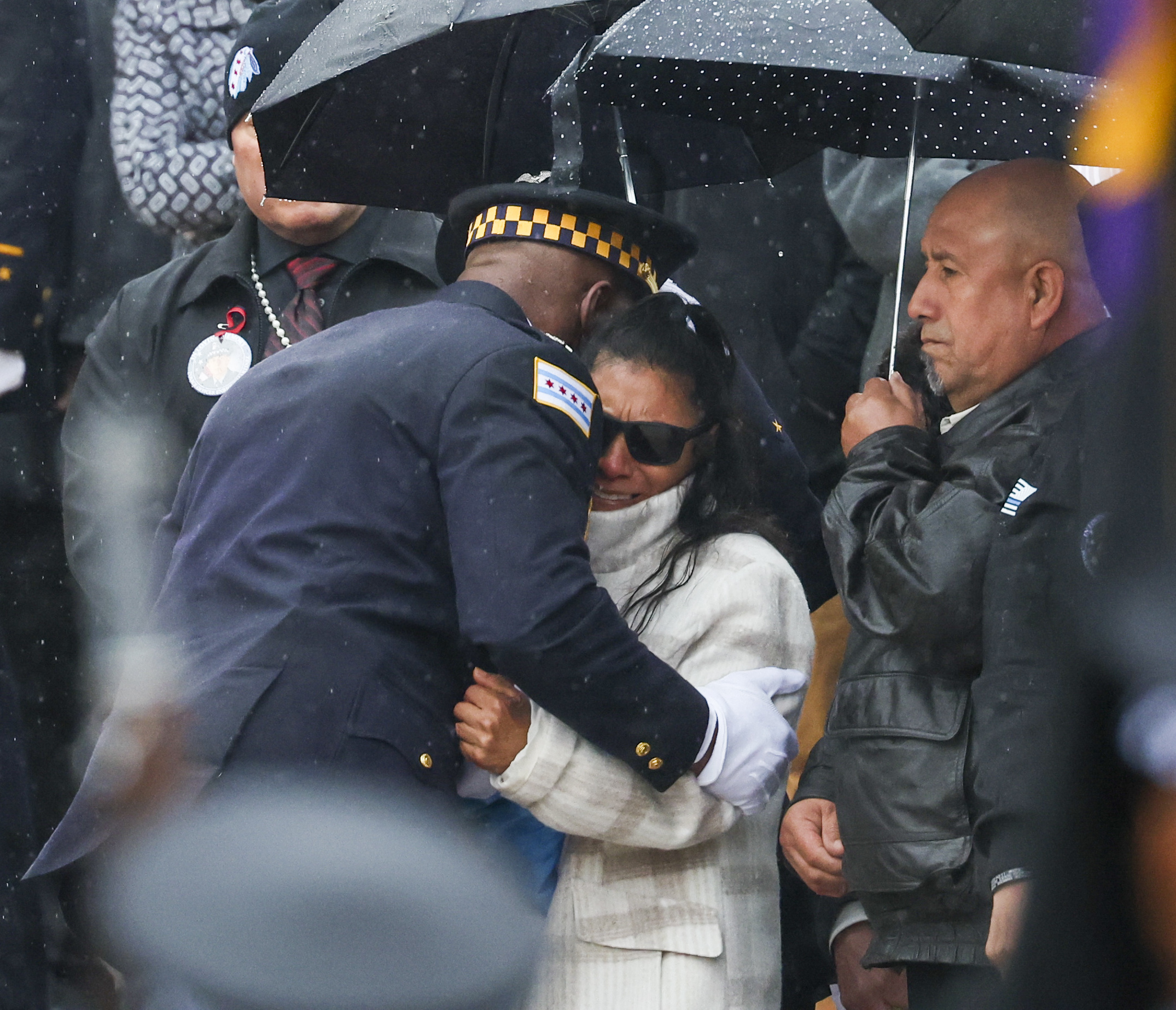 Superintendent Larry Snelling hugs Rosa Mayen, the mother of slain...