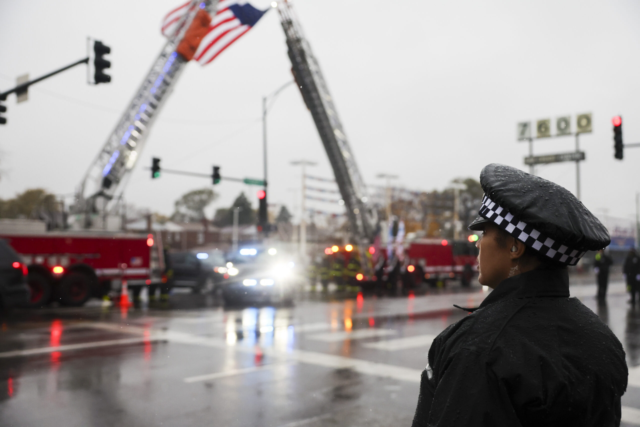 A police officer waits for the hearse of slain Chicago...