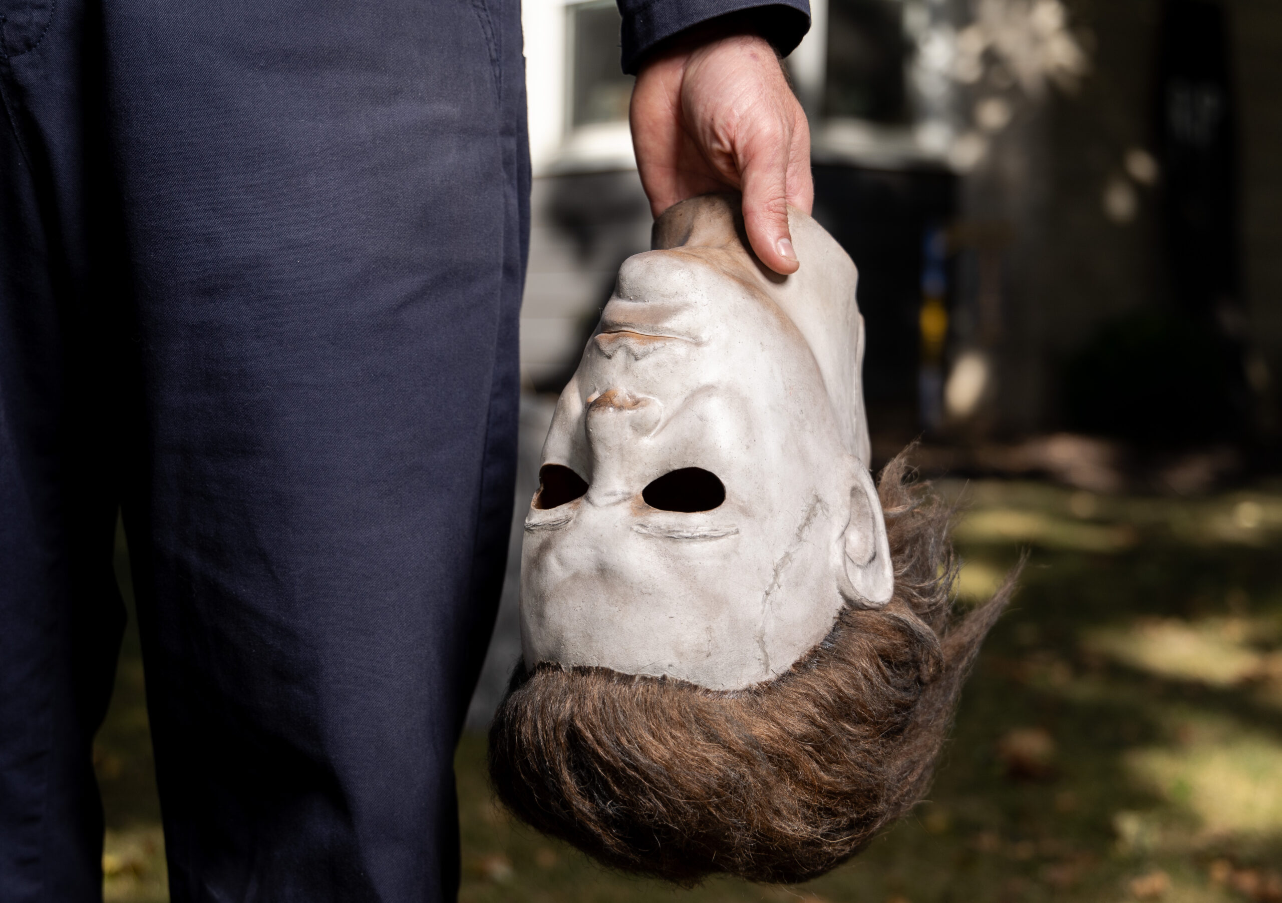 Evan Zimmerman holds his Michael Myers in the front yard...