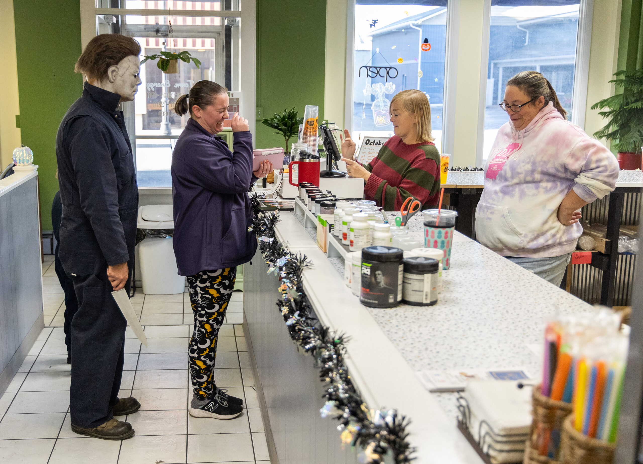 Evan Zimmerman, left, stands behind Kendra Ludwig, middle, of Decatur...