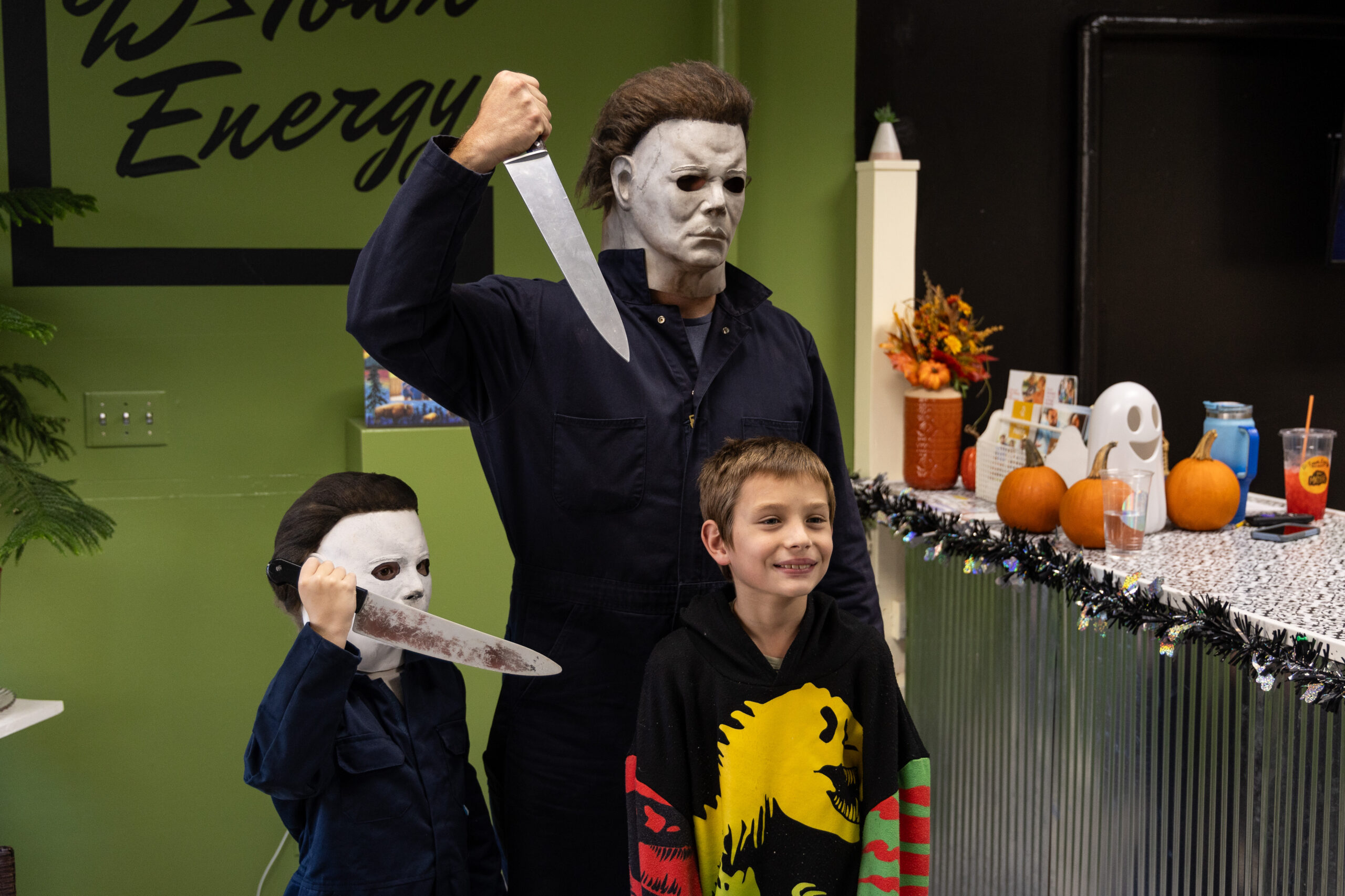 Evan Zimmerman, back, and his son Harrison, 7, left, pose...
