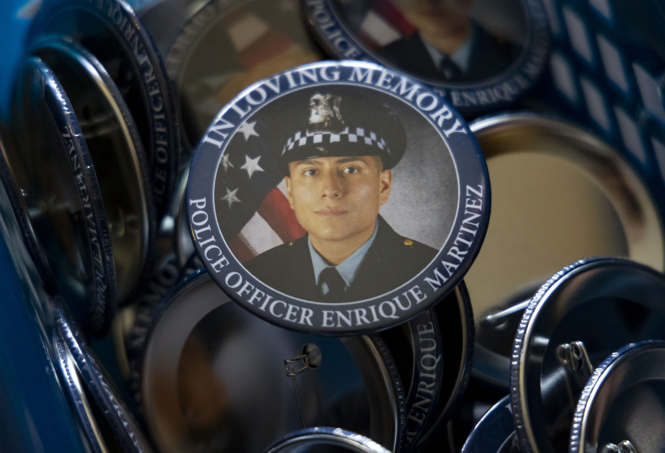 Chicago police Officer Enrique Martínez buttons are distributed before a...