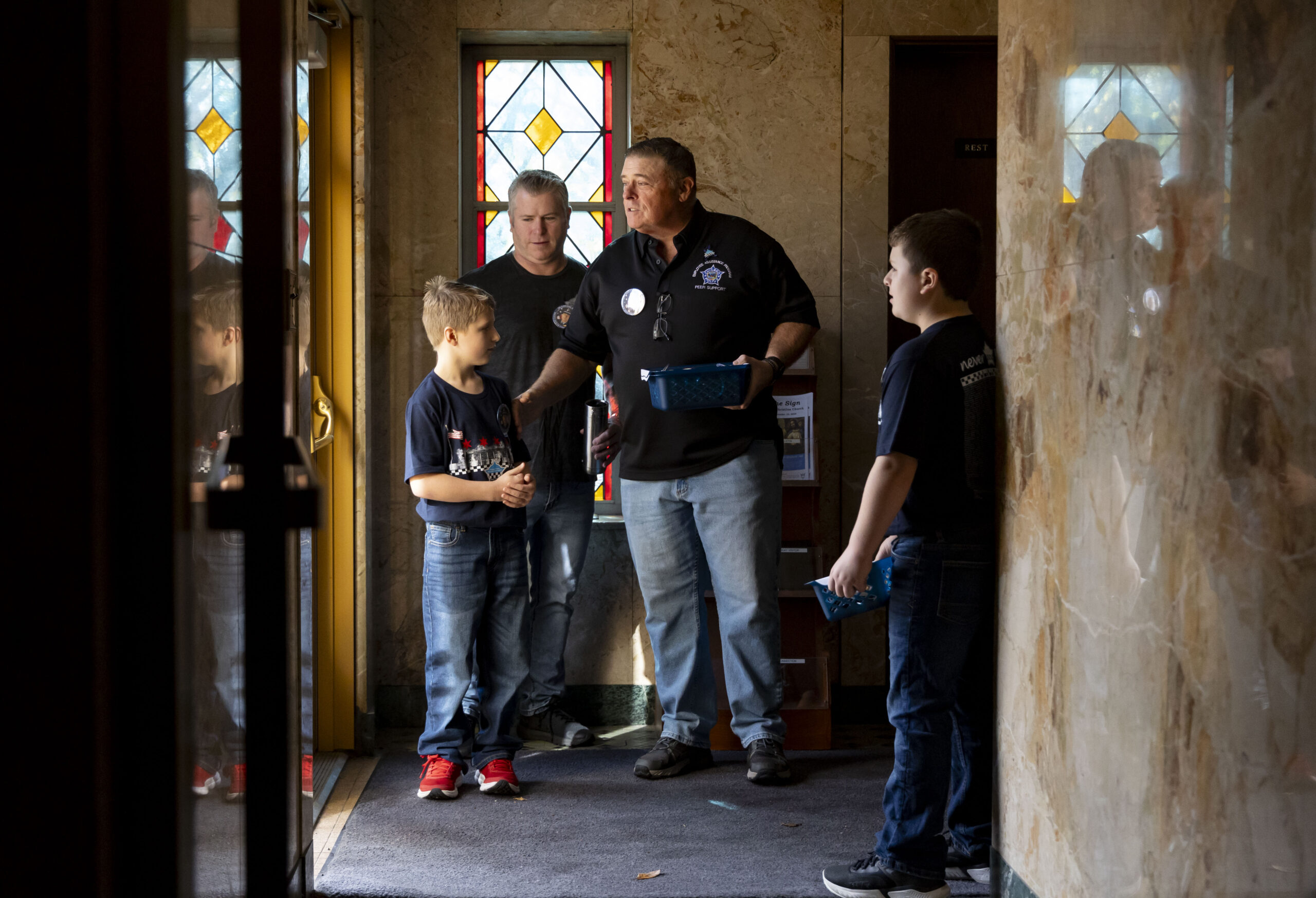 People distribute buttons with a picture of slain Chicago police...