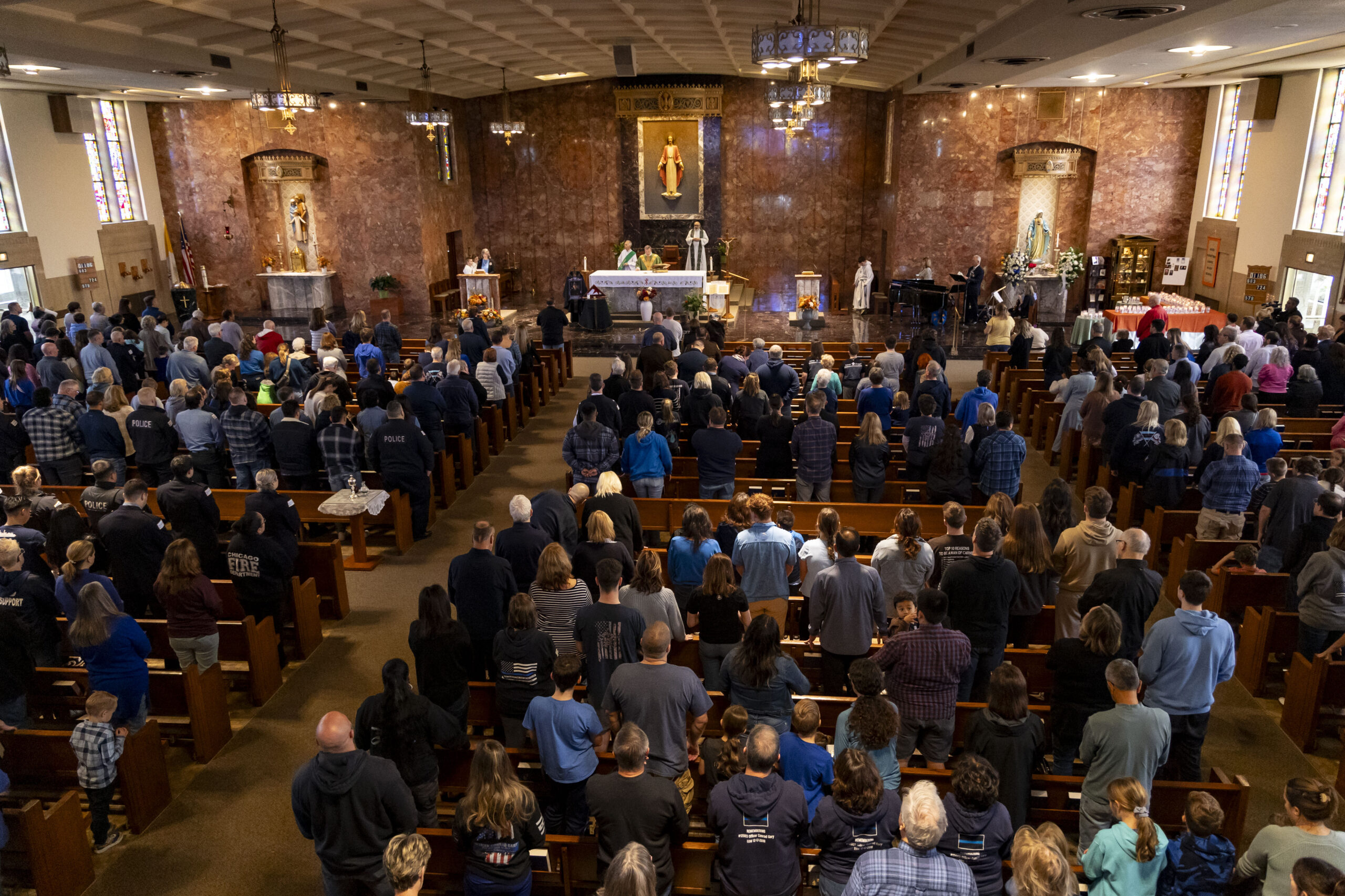 People attend a Mass dedicated to slain Chicago police Officer...