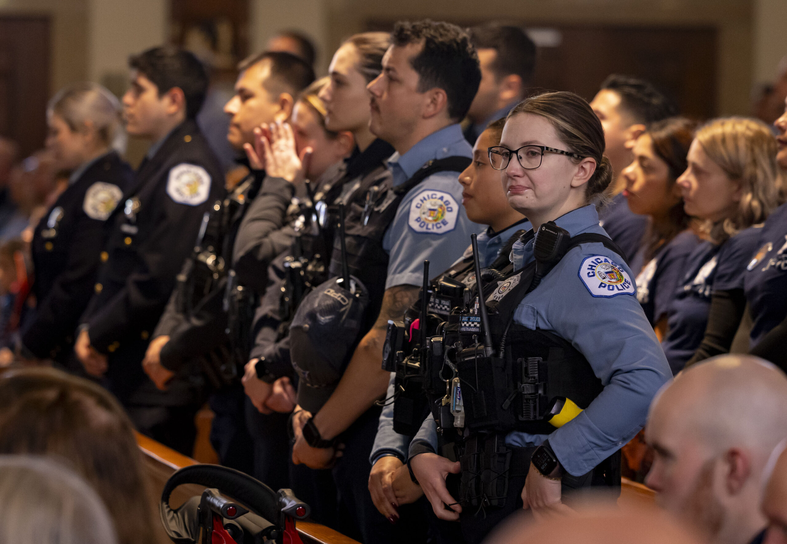 Chicago police officers are recognized during a Mass dedicated to...