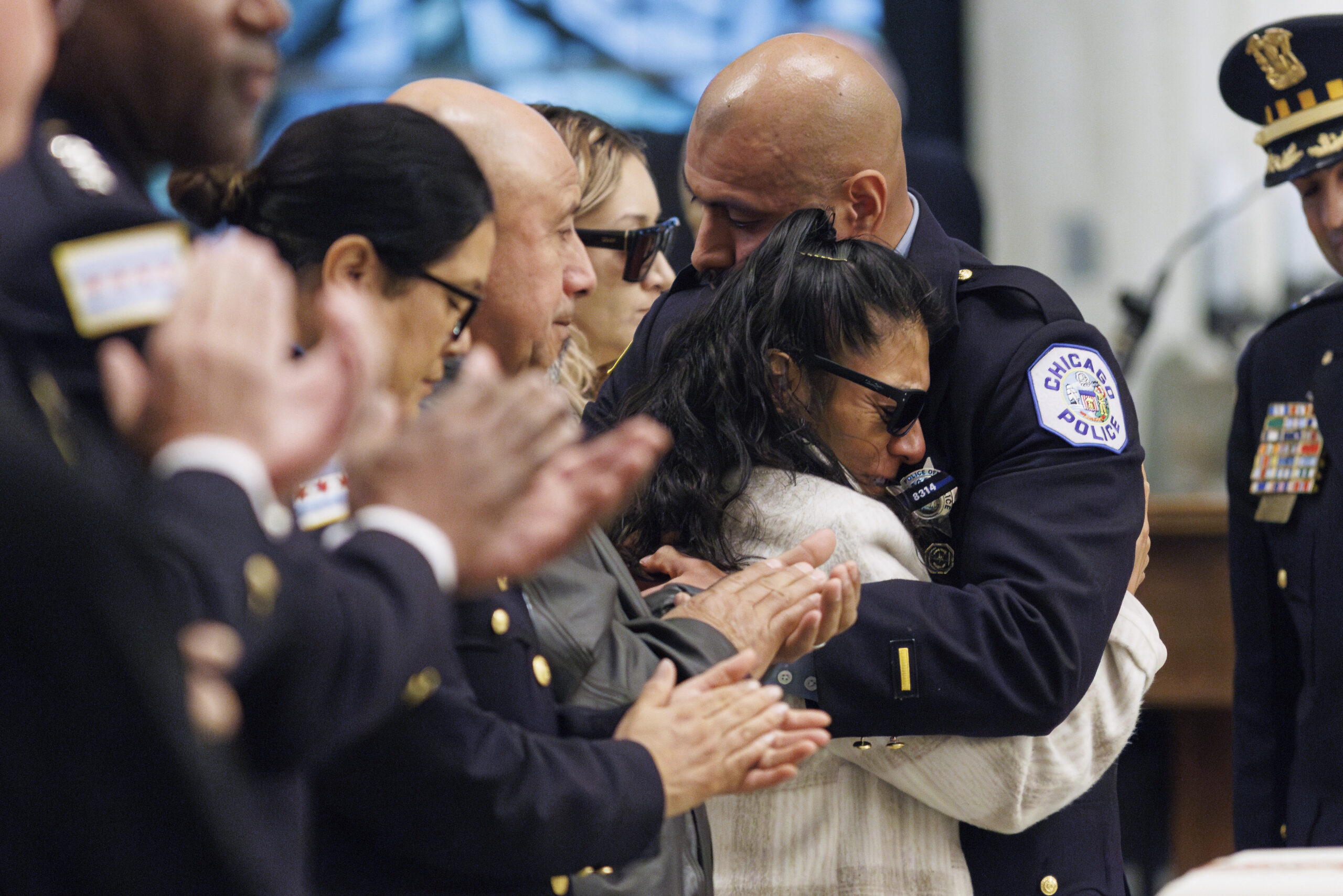 Adrian Martínez Jr. hugs his mother, Rosa Mayen, after speaking...